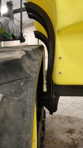 Lakestate Mfg showing tank clearance with a side mount on a tractor with a track.